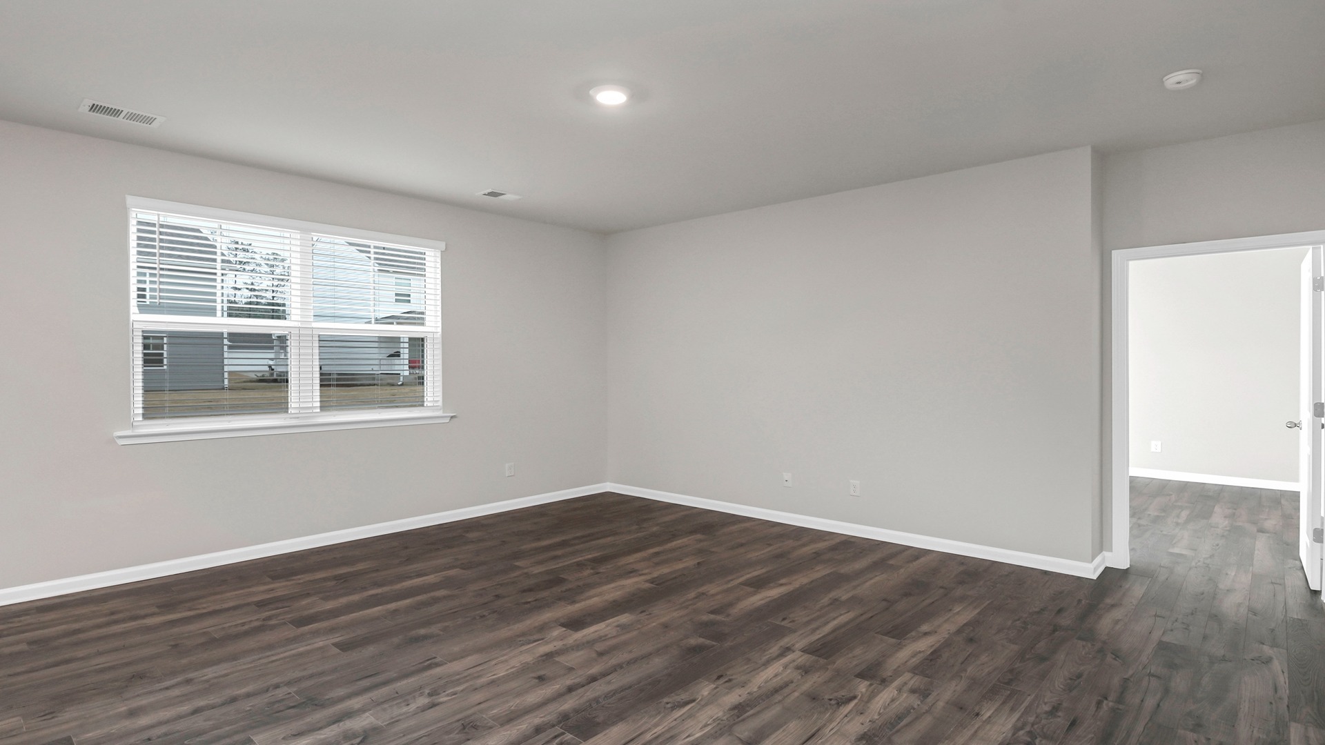 Living area is spacious with windows for light and Revwood flooring