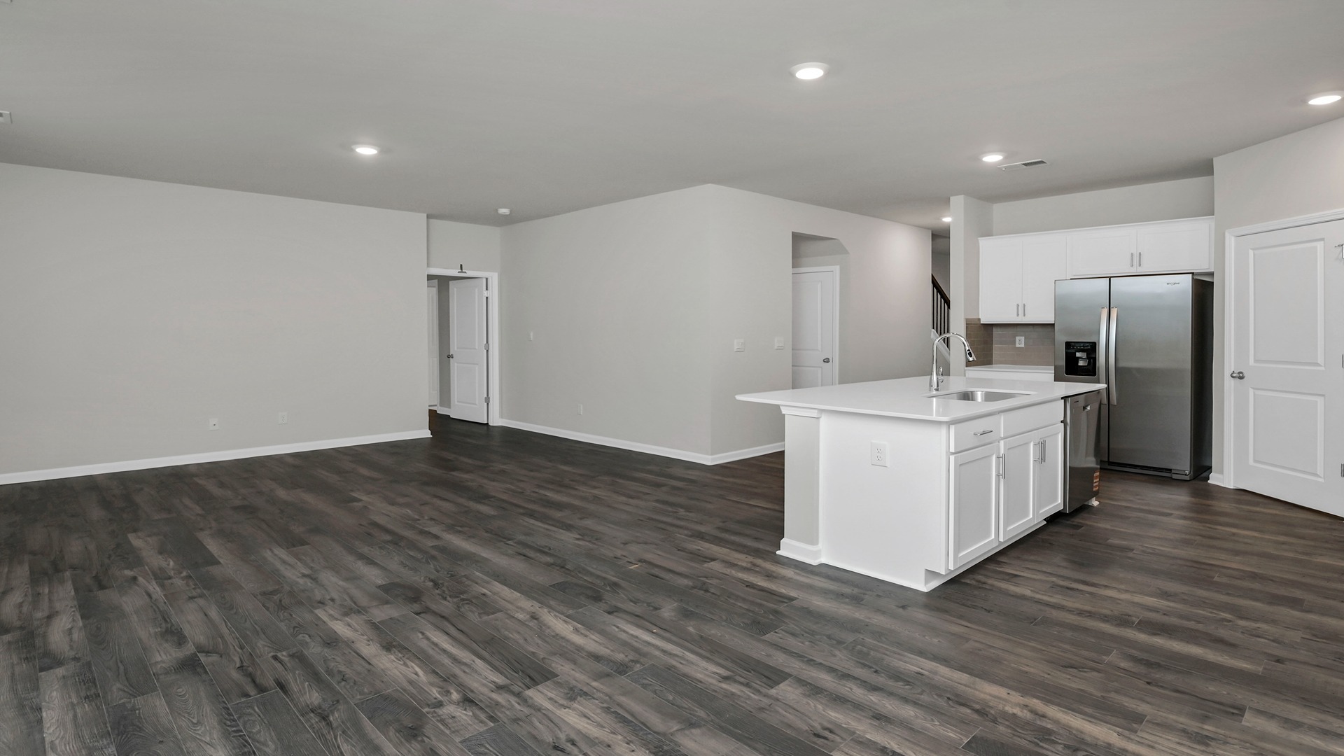 View of kitchen and living areas from the dining space