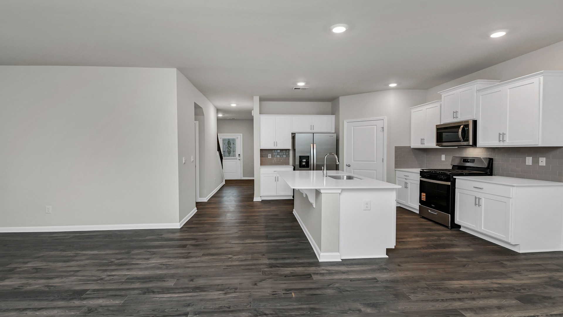 Stainless steel appliances and tile backsplash in the Elle kitchen