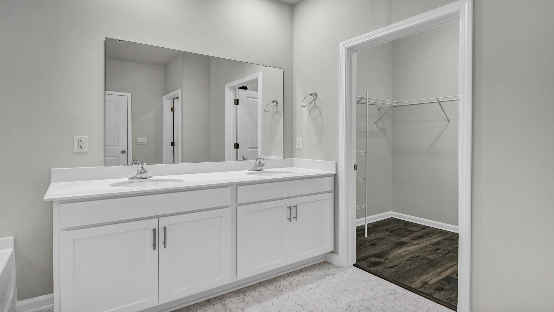 Double vanity in primary bathroom and walk-in closet
