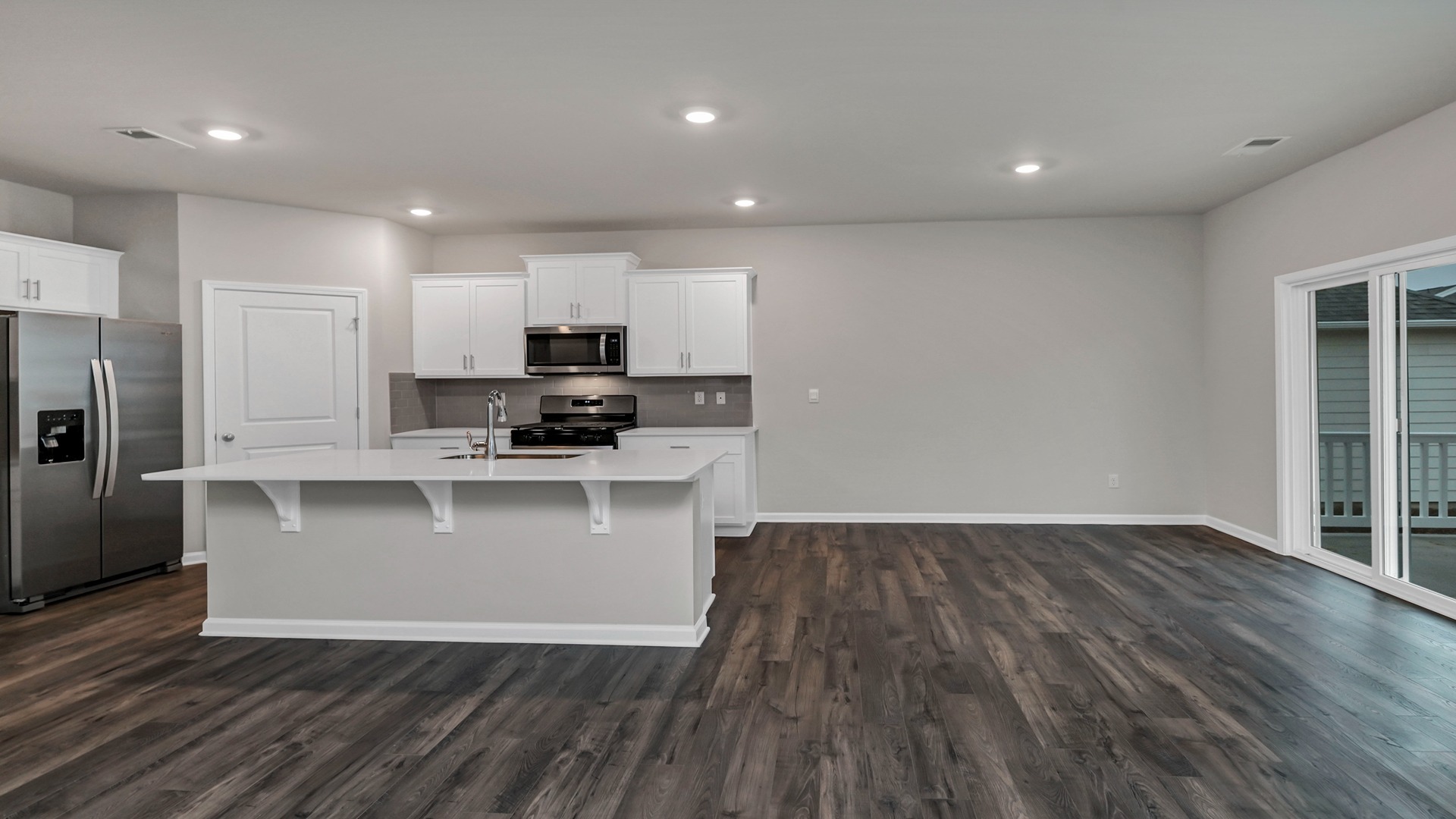 Open concept dining and kitchen areas with RevWood flooring