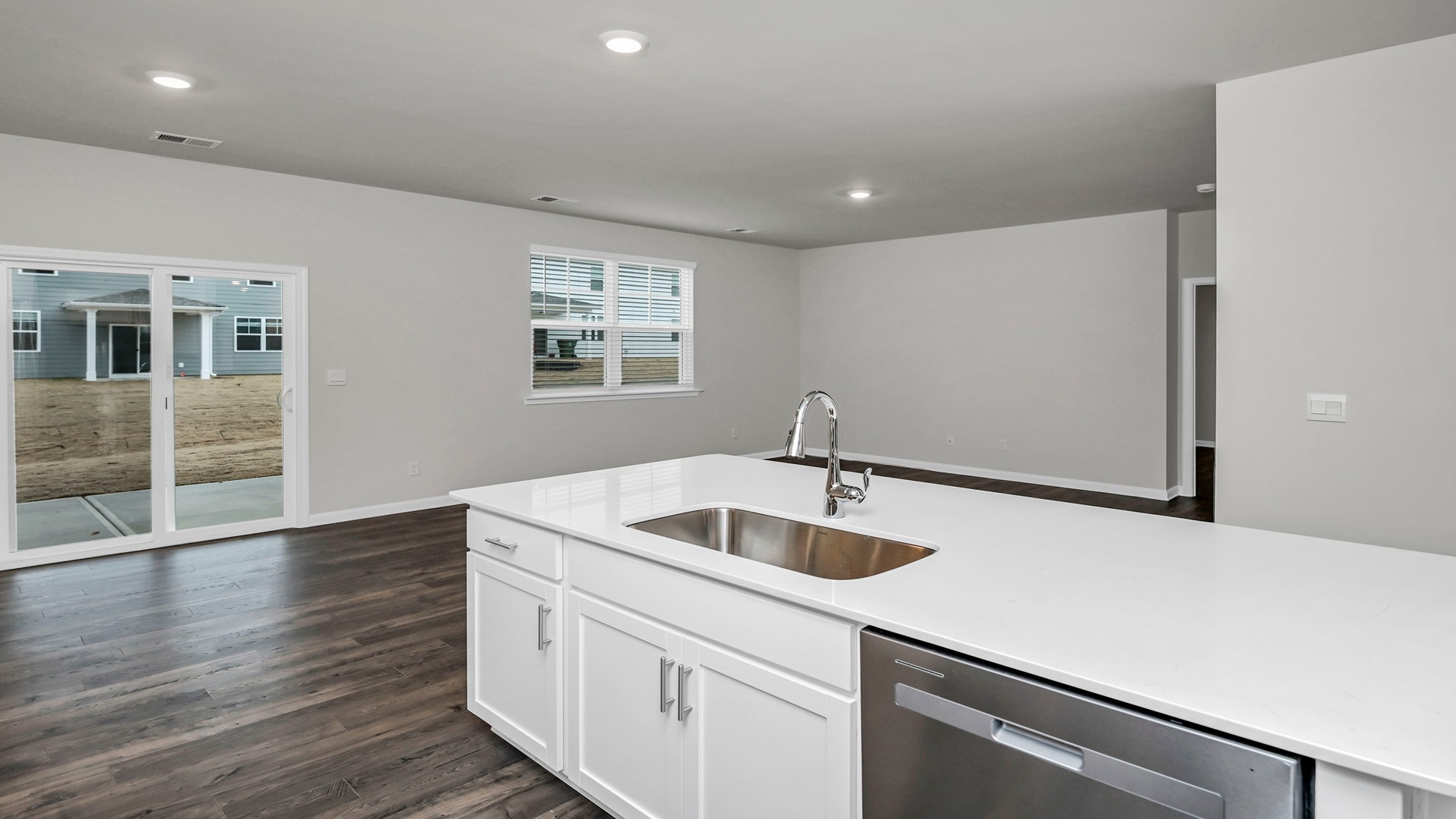 Kitchen sink overlooks dining and living areas