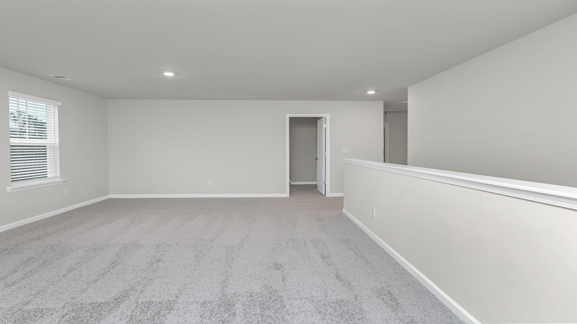 Secondary living space with carpet flooring upstairs