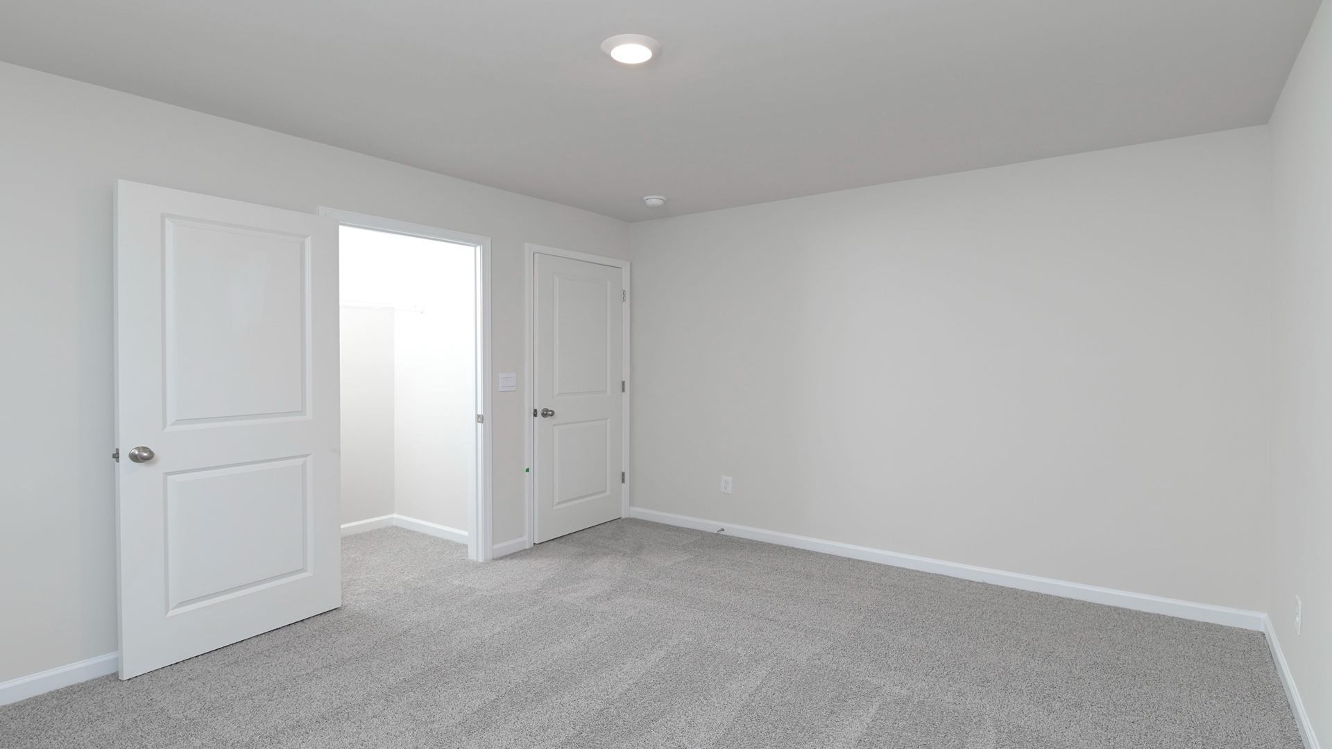 Bedroom 3 with carpet flooring and a walk-in closet