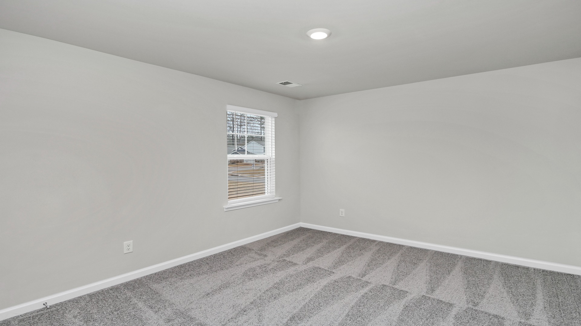 Bedroom 3 with carpet flooring and a walk-in closet