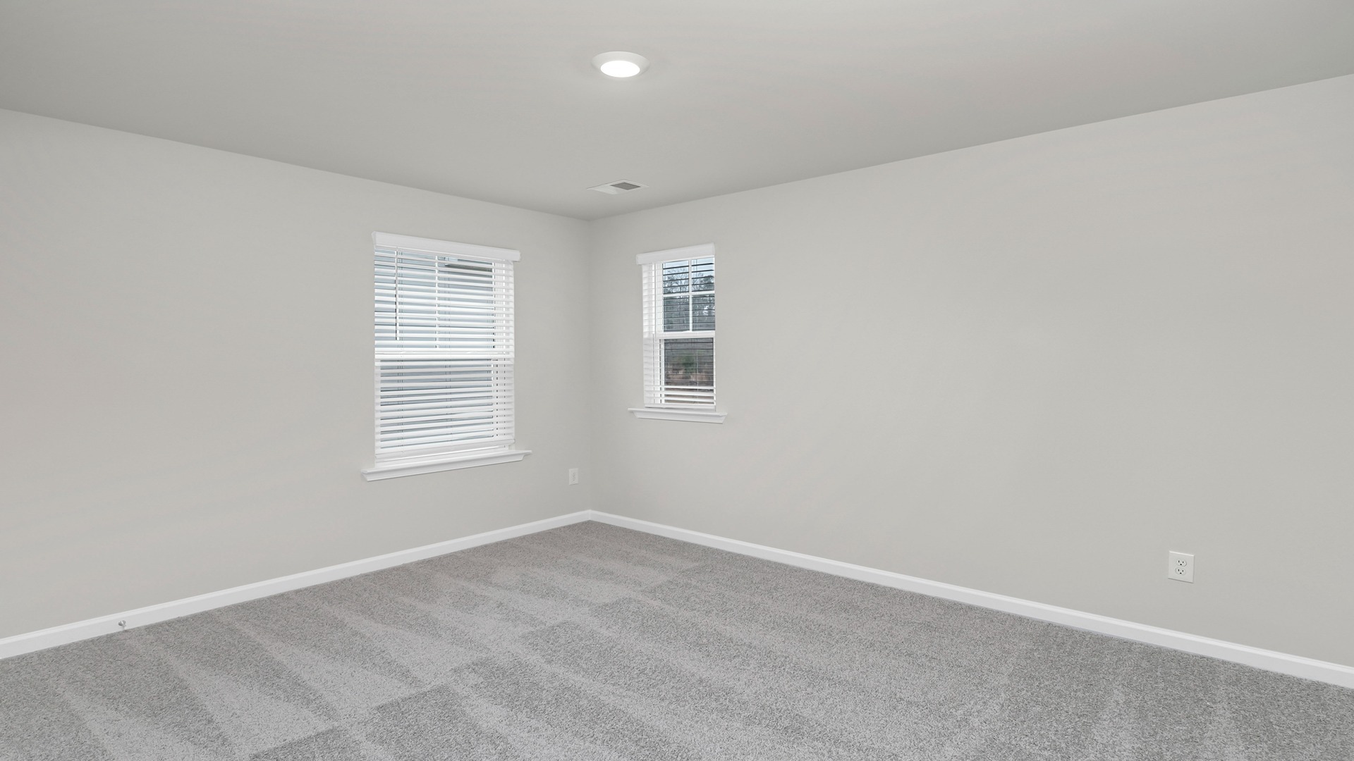 Bedroom 2 upstairs with 2 windows and a walk-in closet