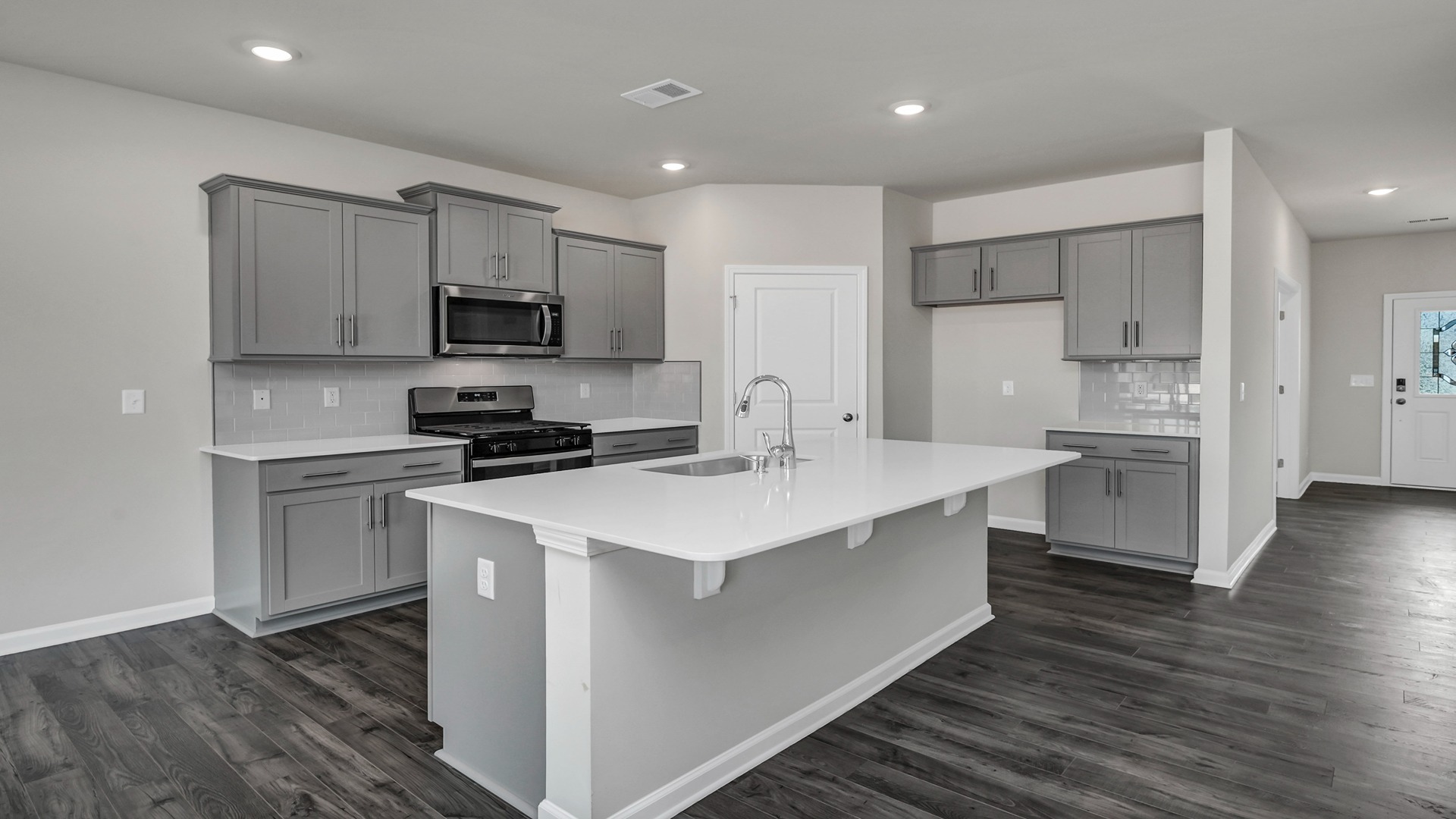 Front foyer opens up into the kitchen space of new construction home for sale