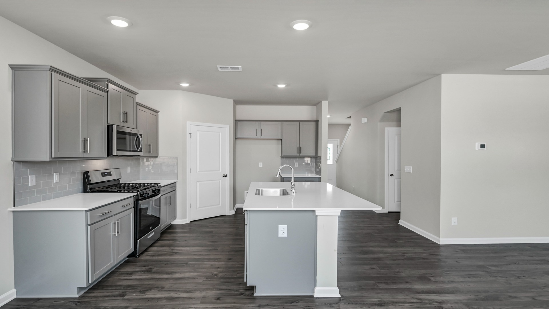 Gray cabinets in kitchen and brand-new stainless-steel appliances