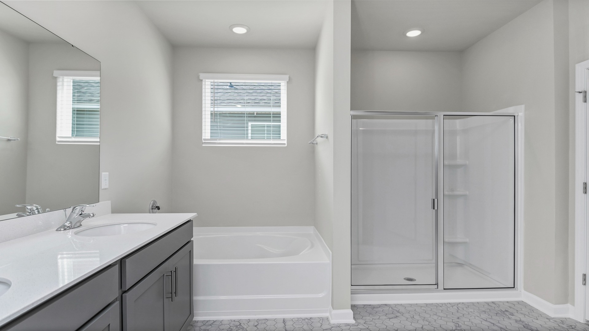 En-suite primary bathroom with a walk-in shower and double vanity