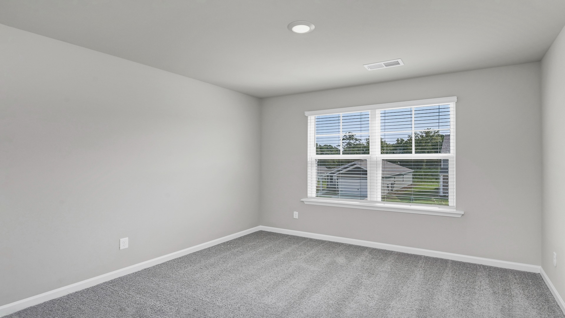 Upstairs living area with carpet floors and windows for light