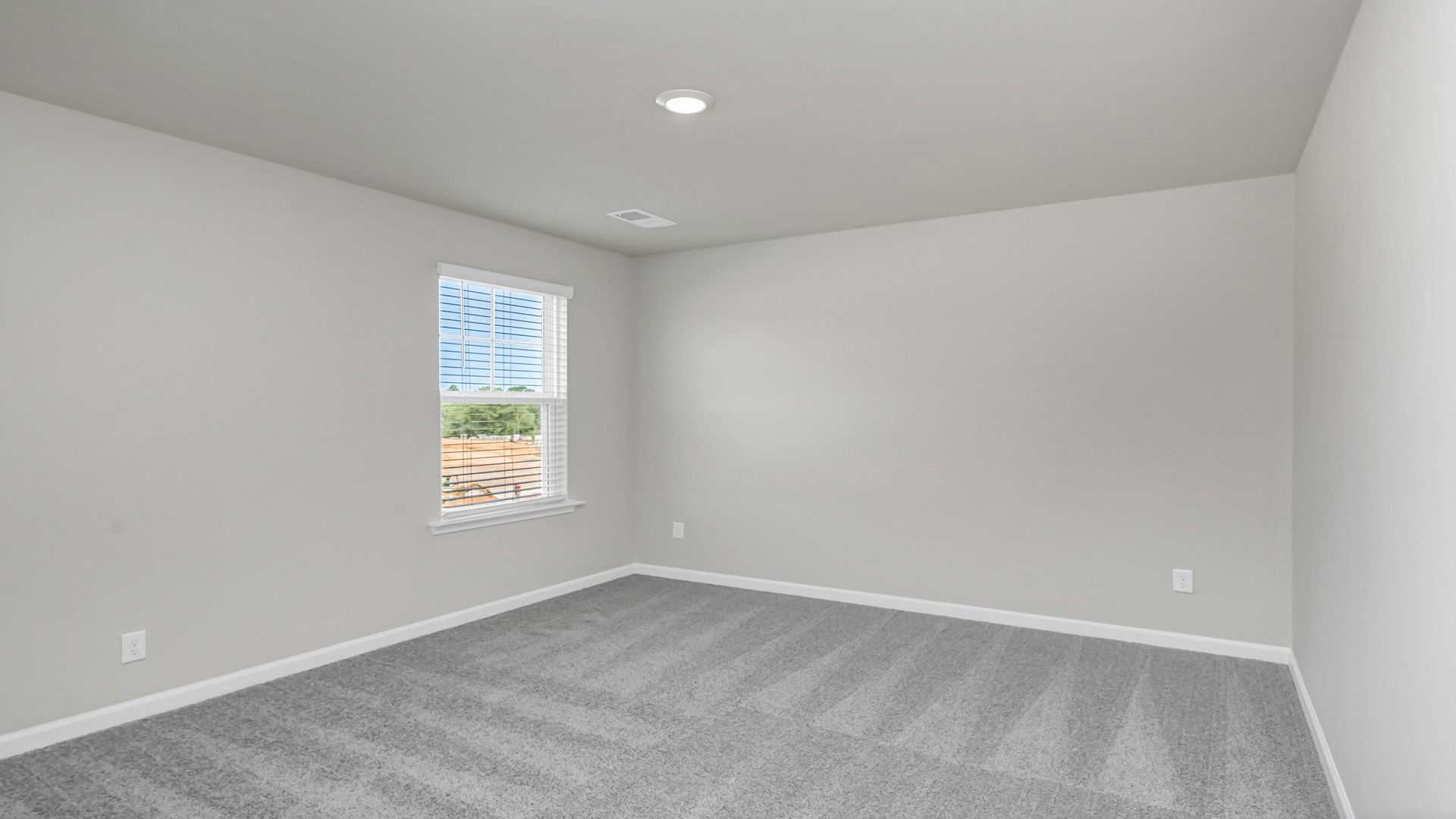 Bedroom 5 upstairs with carpet floors and a window for light