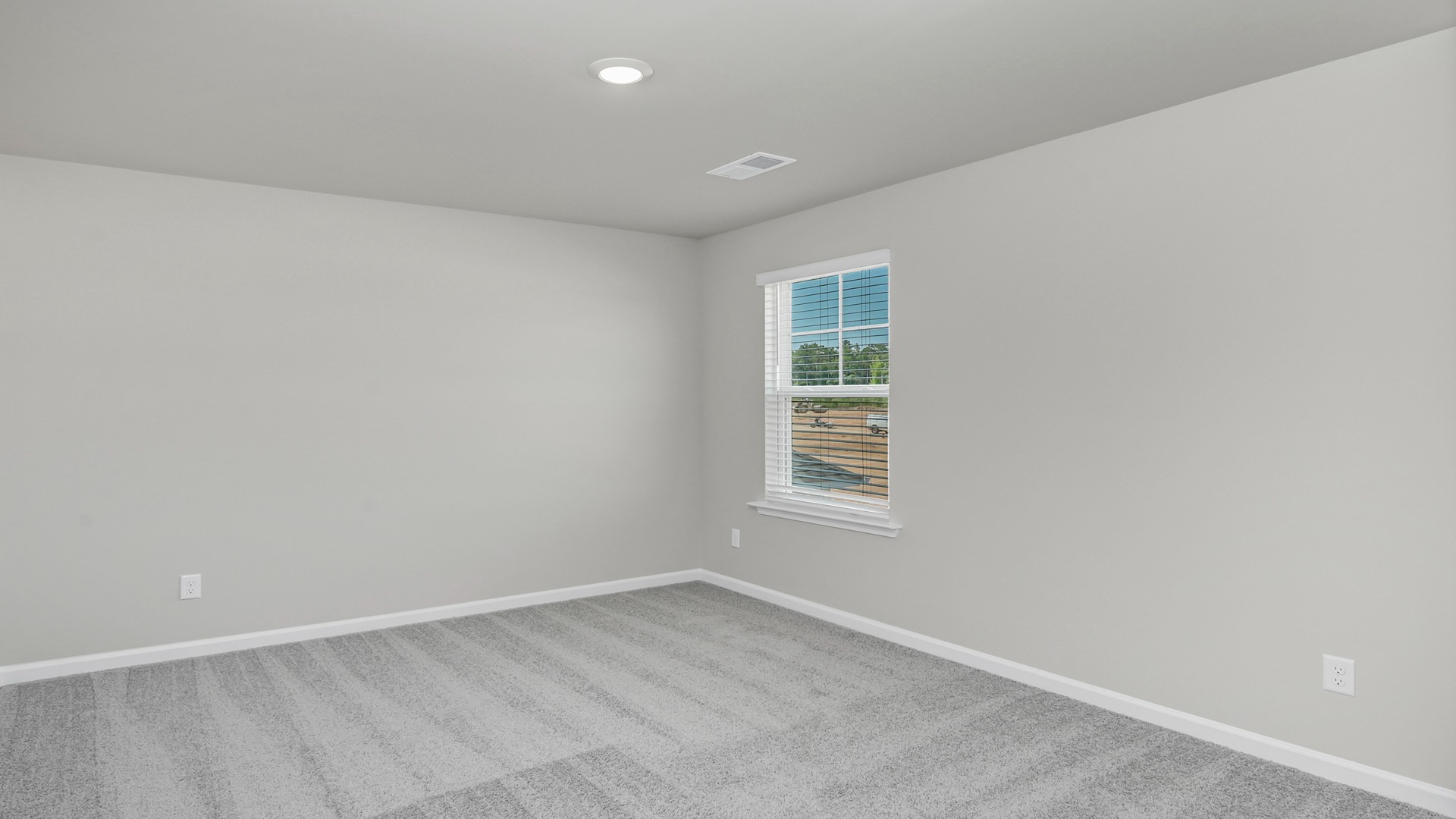 Bedroom 4 upstairs in the Elle floor plan with neutral walls and a window for light