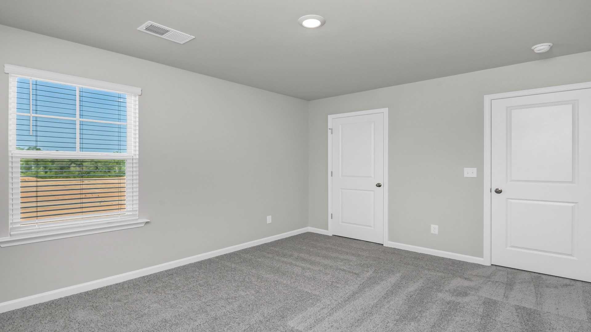 Carpet floors and a closet in bedroom 4 upstairs in new construction home