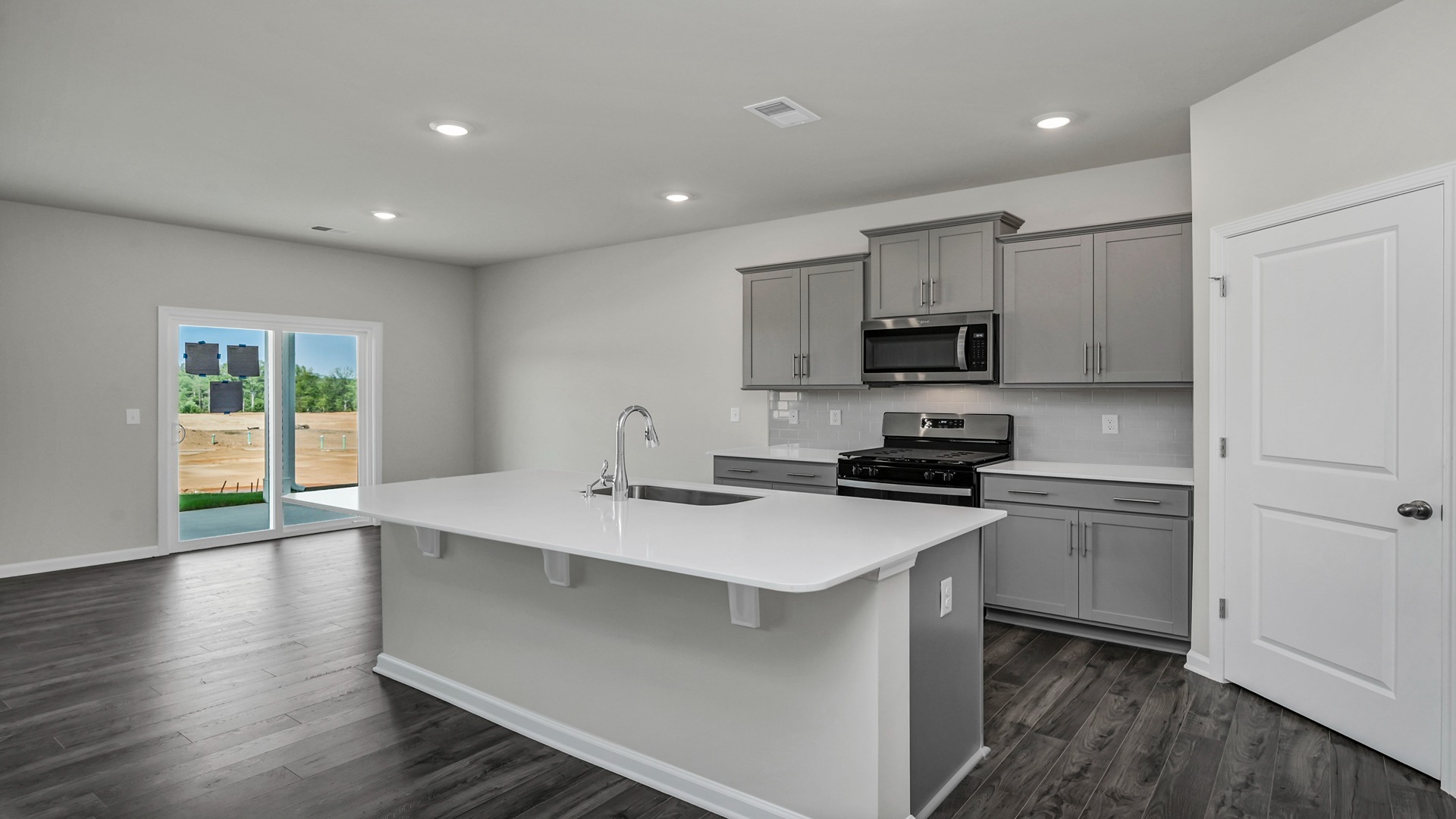 Elle kitchen space with gray cabinets and a floating kitchen island