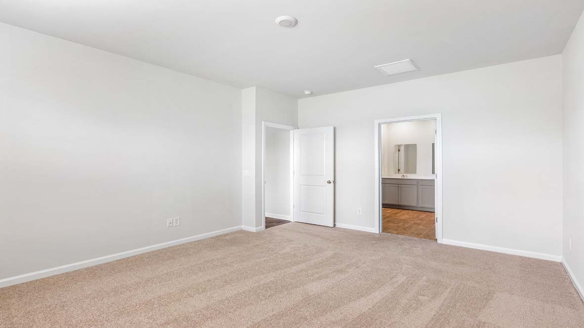 The primary bedroom is downstairs with a large window for light.