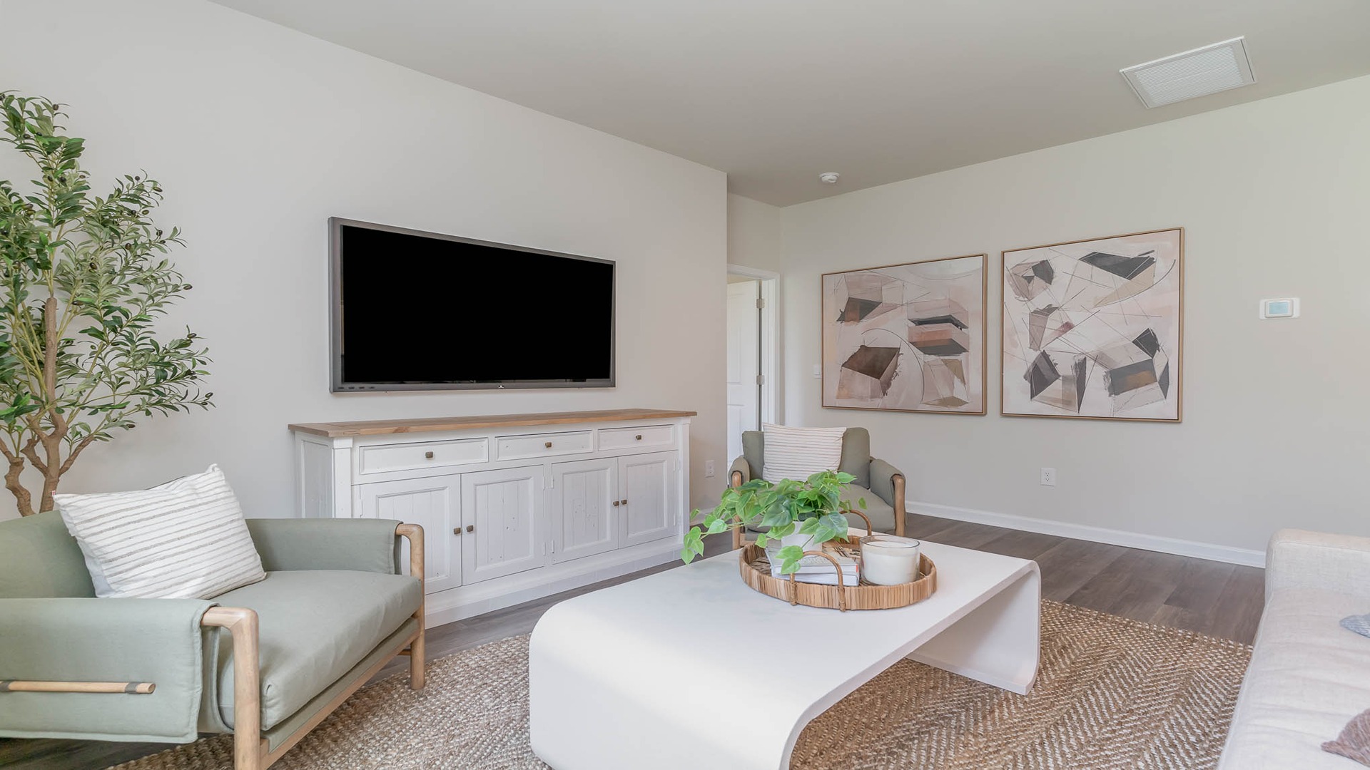 Living area with Revwood flooring and a large window for light