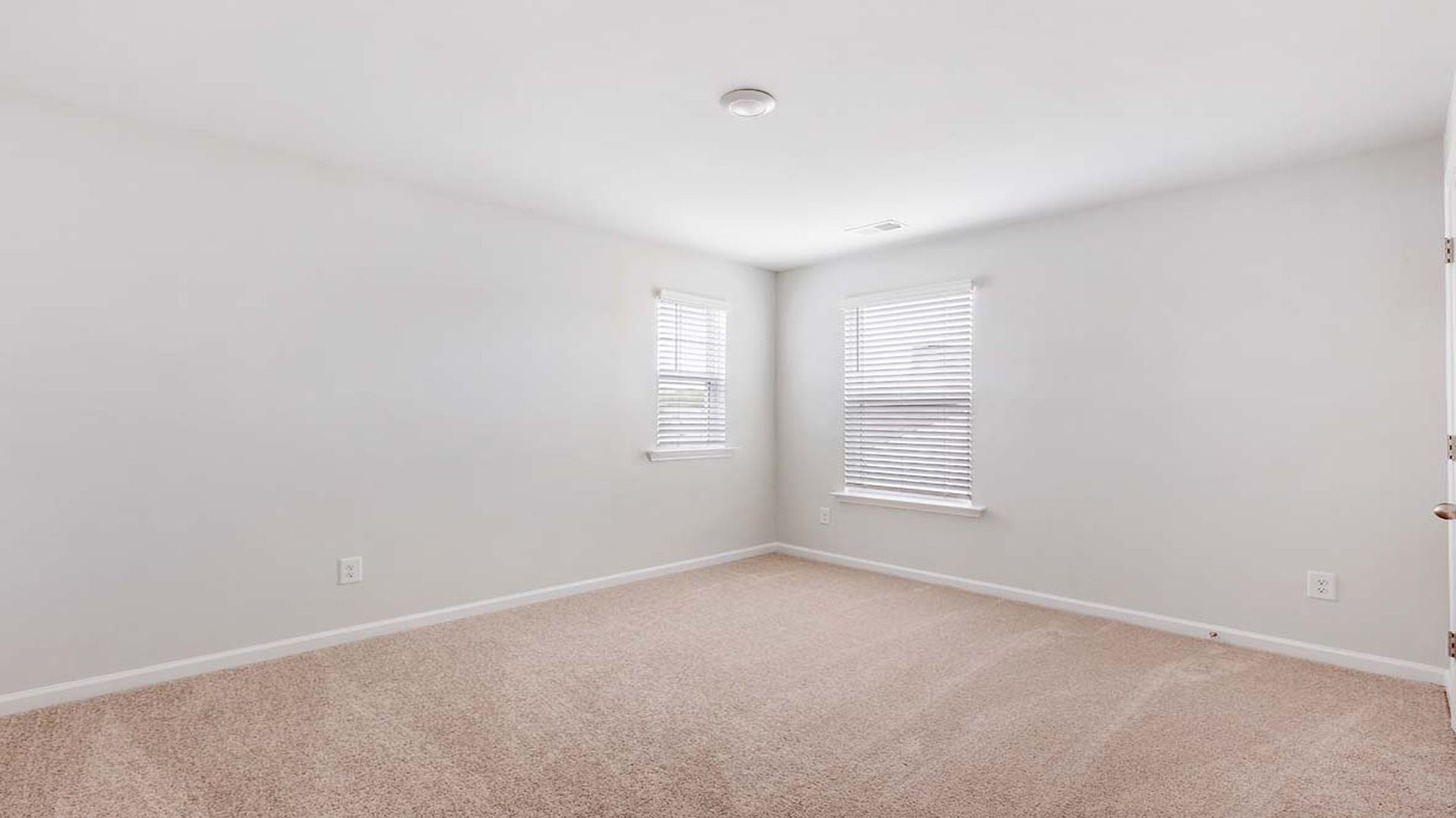 Bedroom 2 is located upstairs and is carpeted with 2 windows.
