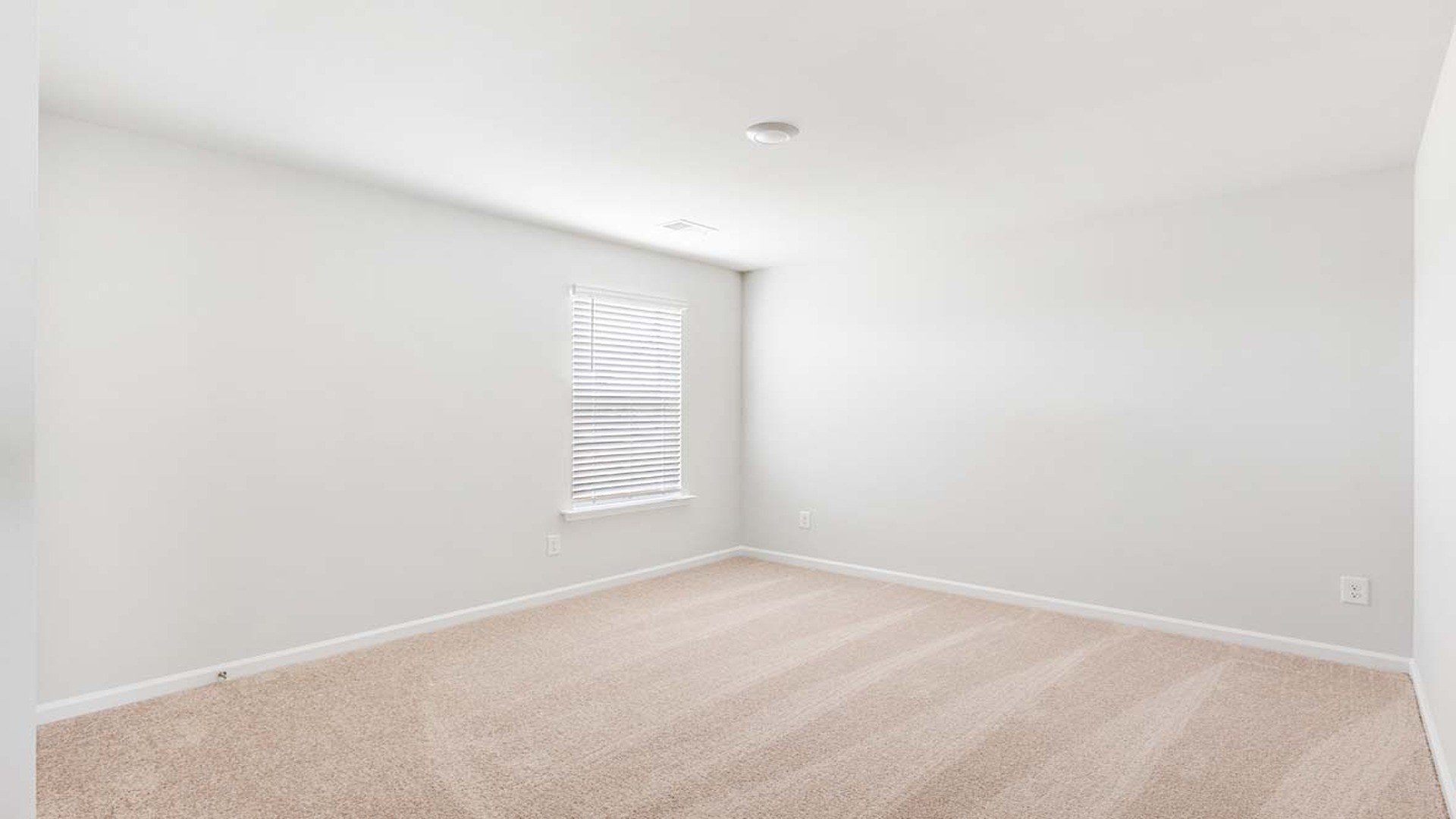 Bedroom 5 upstairs with carpet flooring and a window.