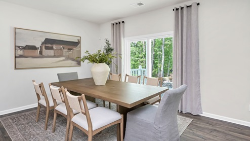 The dining area features ample natural light from back sliding glass doors.