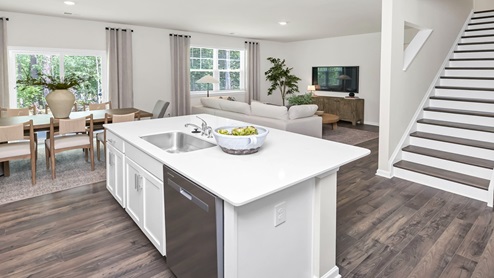 The floating kitchen island overlooks the living area and stairway to upstairs.
