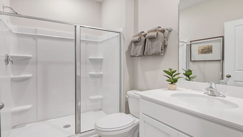 The downstairs full bathroom with standup shower is located across the hall from bedroom 2.