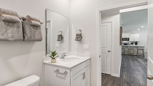 The downstairs full bathroom with standup shower is located across the hall from bedroom 2.