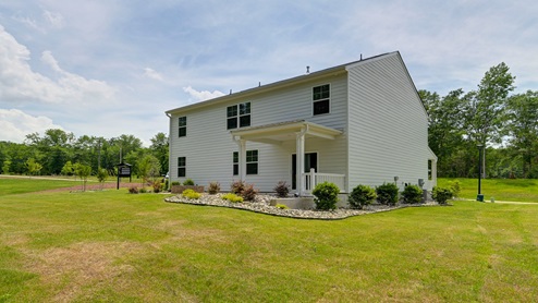 Back exterior of the home and the spacious backyard.