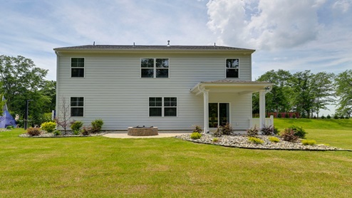 Back exterior of the home and the spacious backyard.