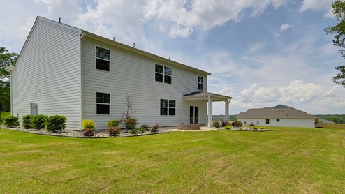 Back exterior of the home and the spacious backyard.