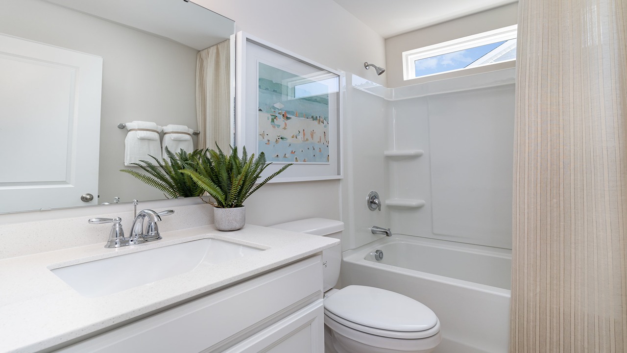 Several bathrooms in each home with quartz countertops and cabinet storage