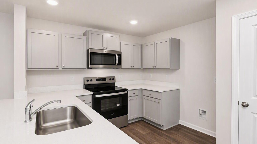 Pearson townhome kitchen with quartz countertops, gray cabinets, and a kitchen pantry