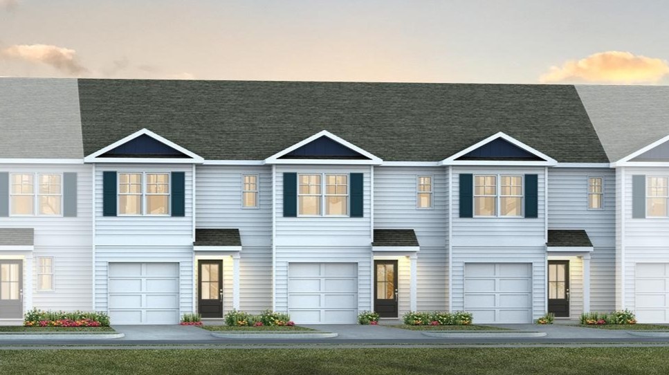 White vinyl siding and a 2-car garage finishes townhome for sale in Hopkins
