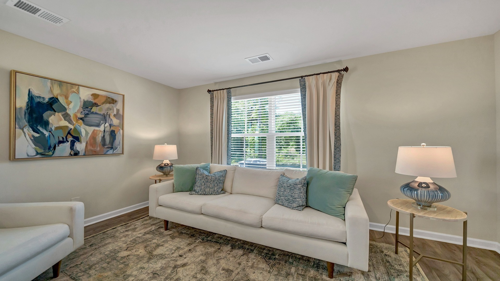 Vinyl floors and natural light in the living area of the Pearson townhome for sale