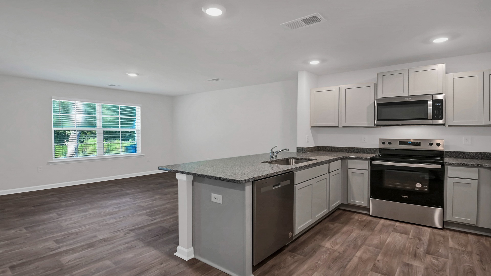 Stainless-steel kitchen appliances and gray cabinetry