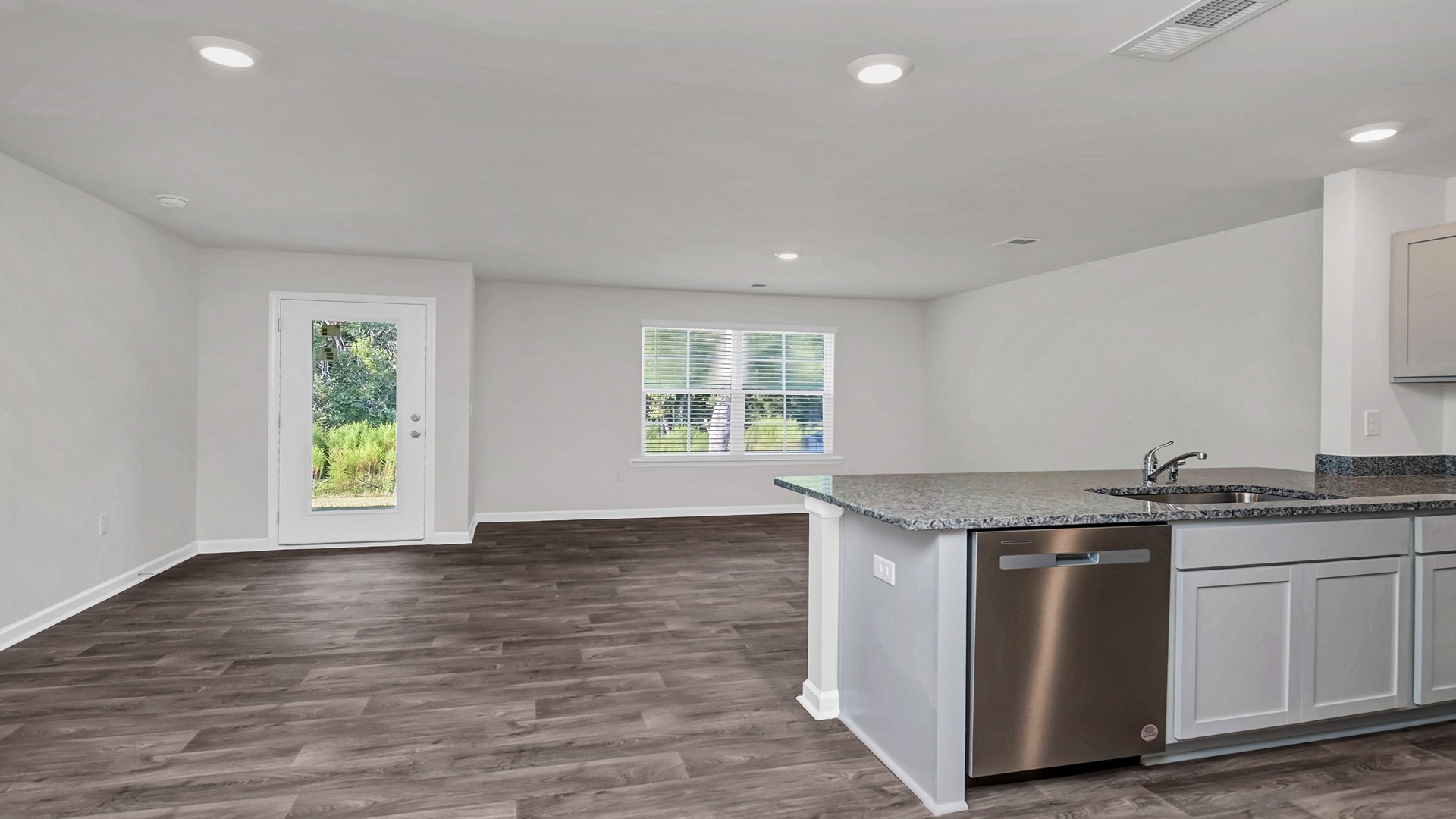 Kitchen bar overlooks living and dining areas