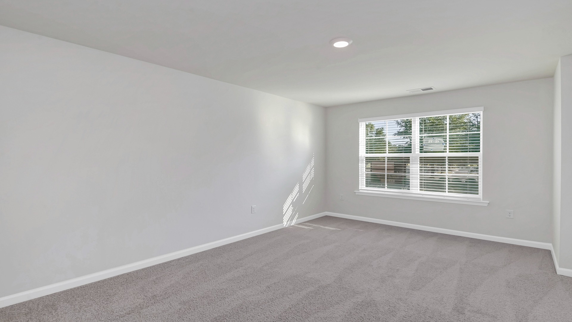 Primary suite upstairs with a large front facing window