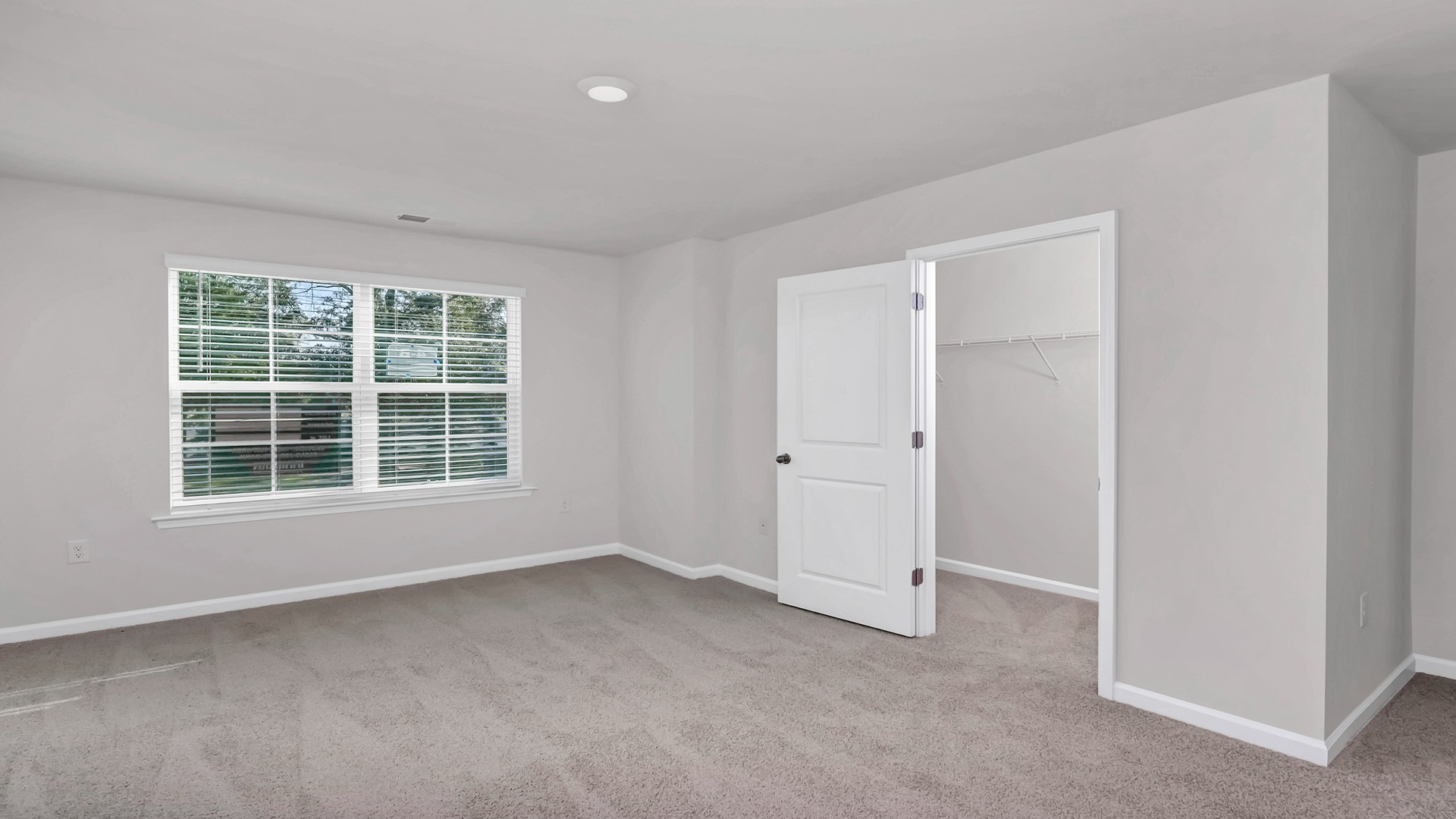 Primary bedroom in the Pearson with a walk-in primary closet