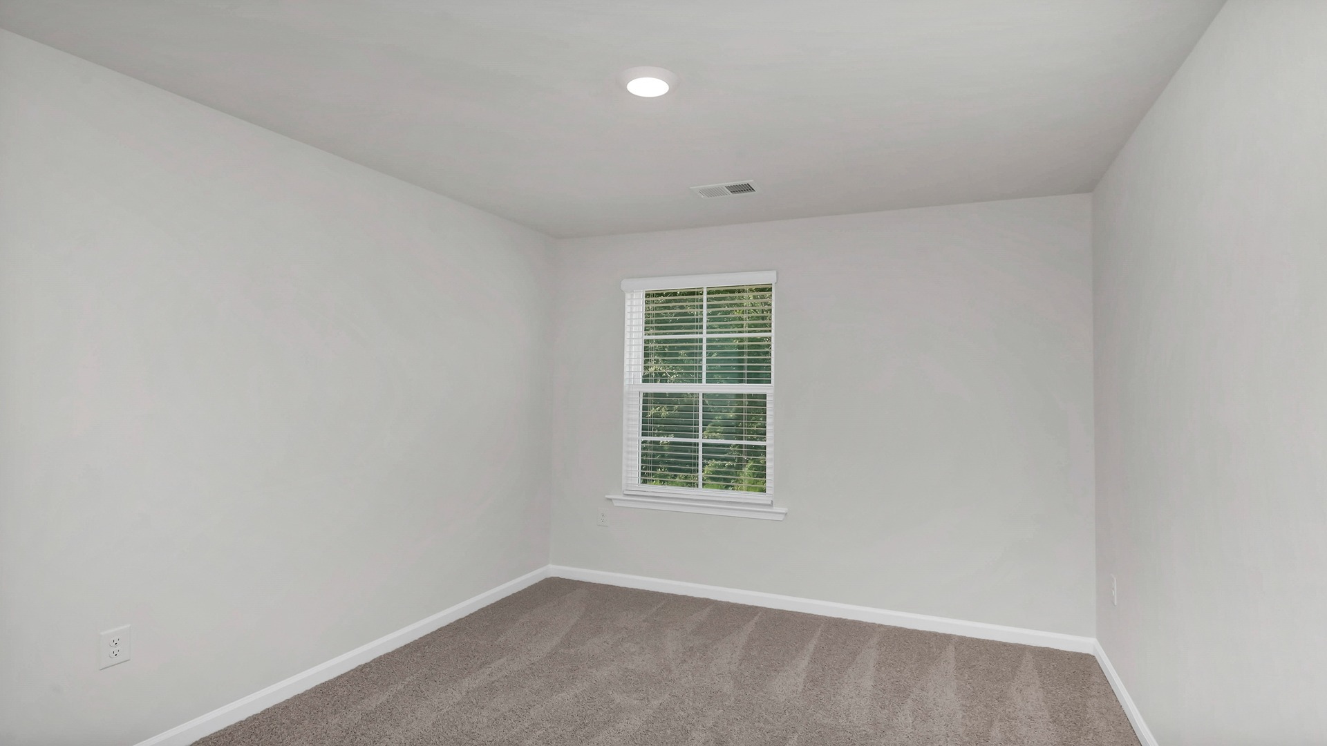 Bedroom 3 with a window for light and carpet flooring