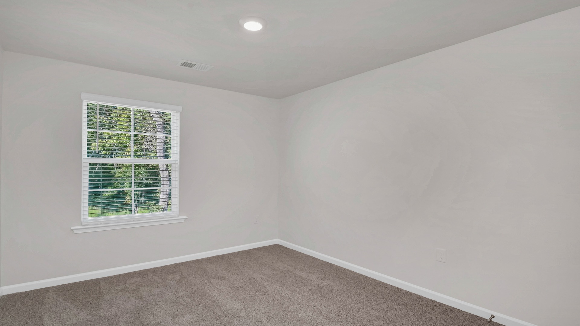 Bedroom 2 with a window and carpet floors