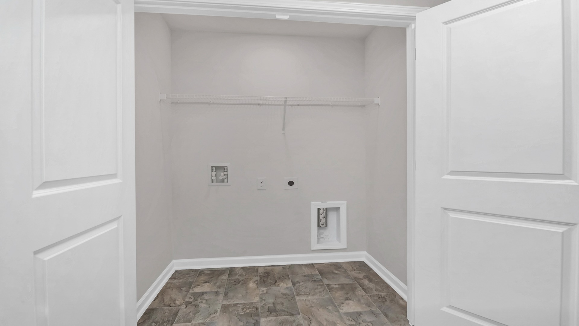 Laundry room upstairs with wire shelving