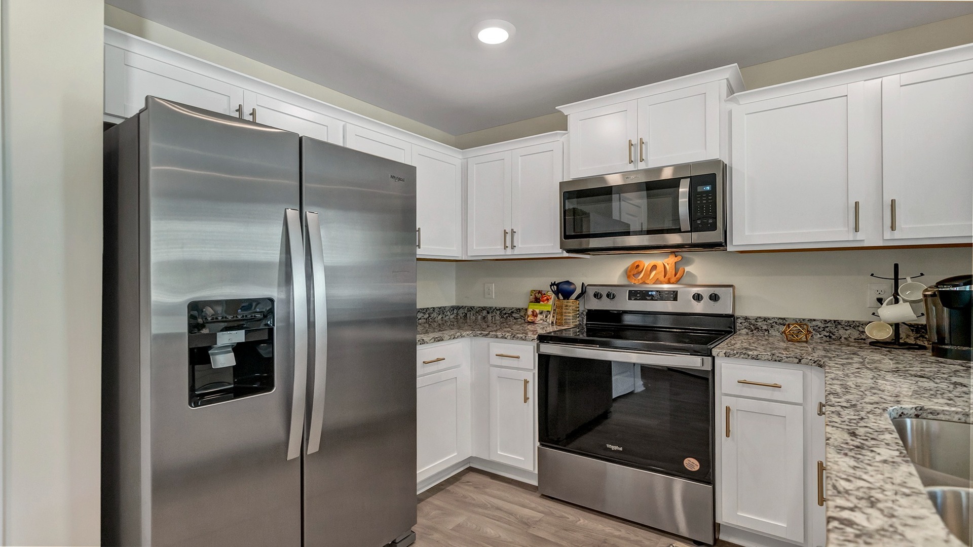 White cabinetry and stainless-steel kitchen appliances