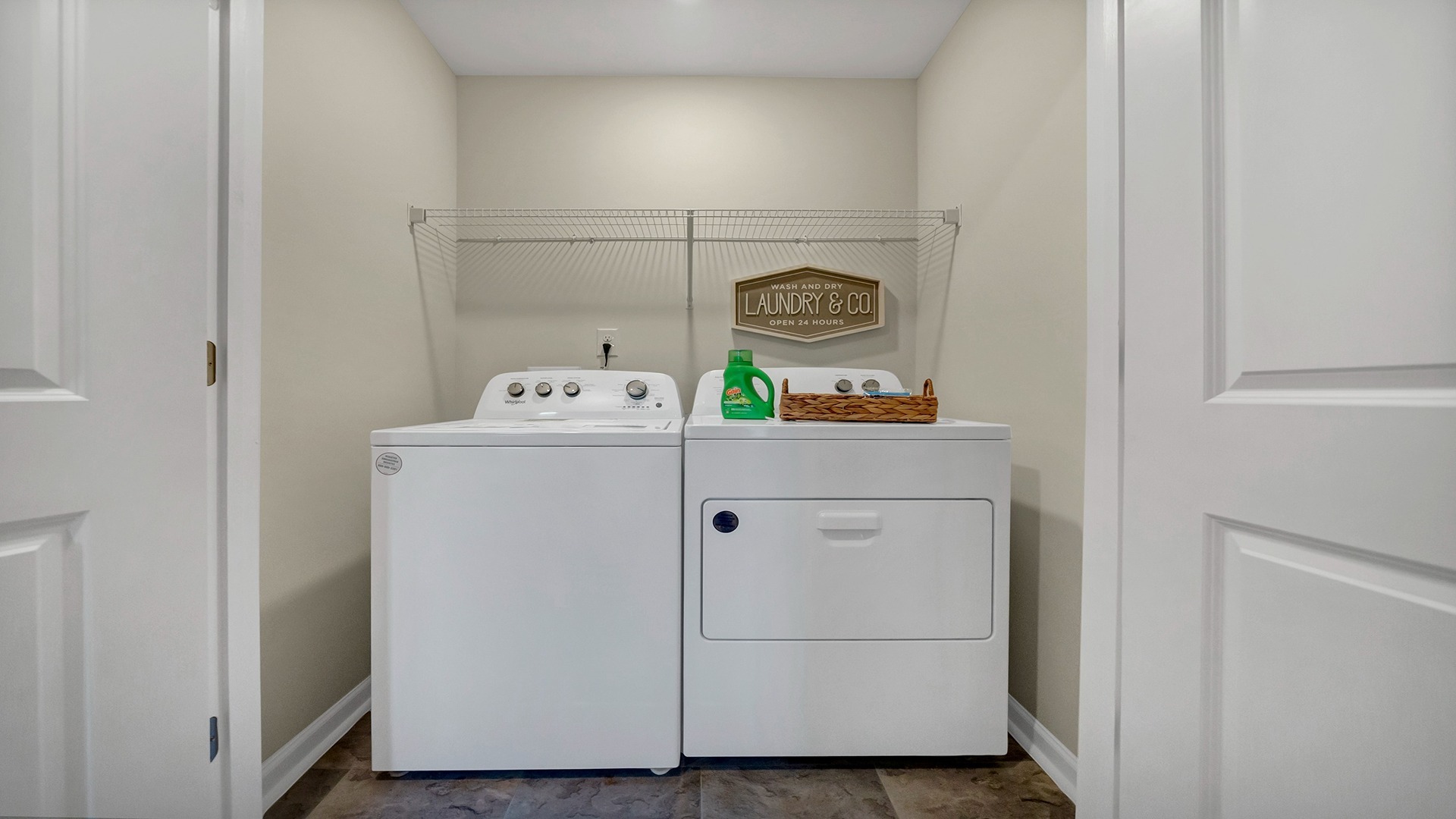 Laundry room upstairs with wire shelving above