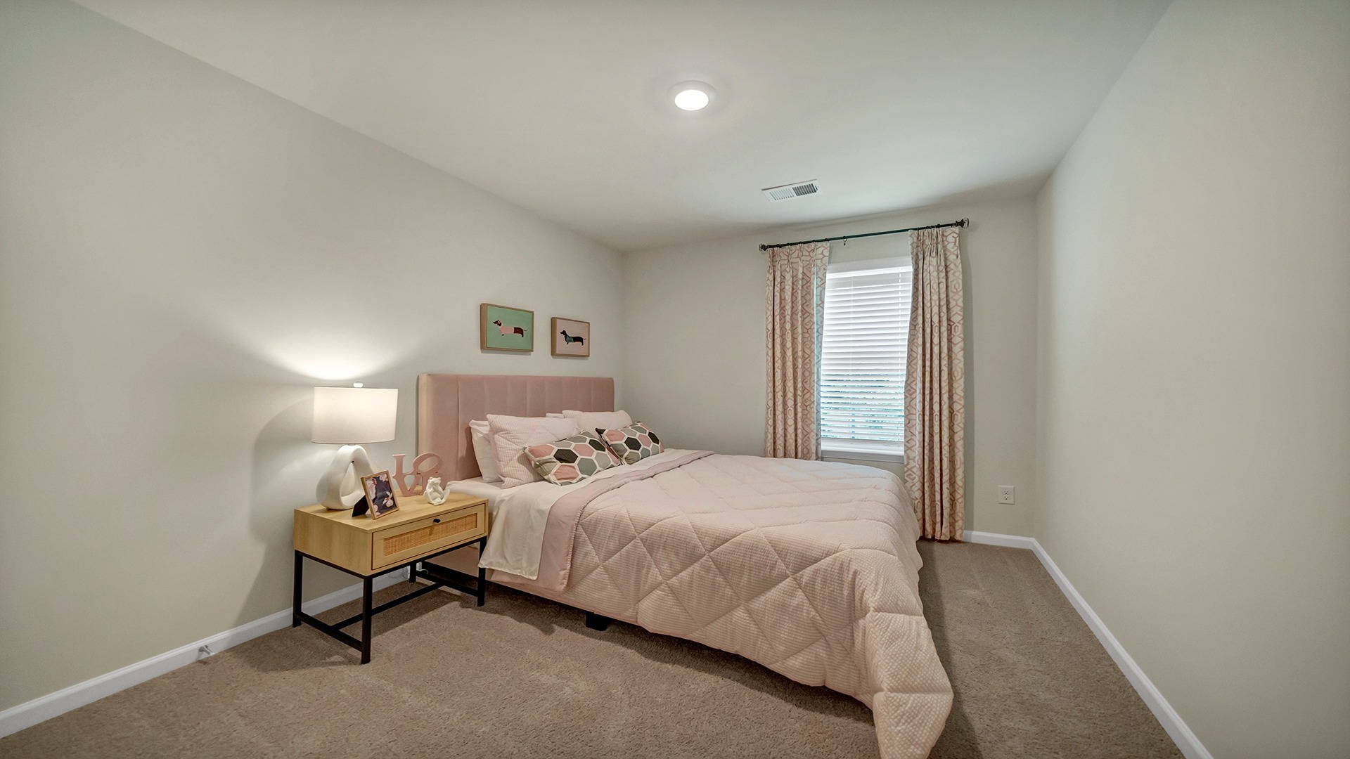 Bedroom 2 upstairs with a window for light and carpet floors