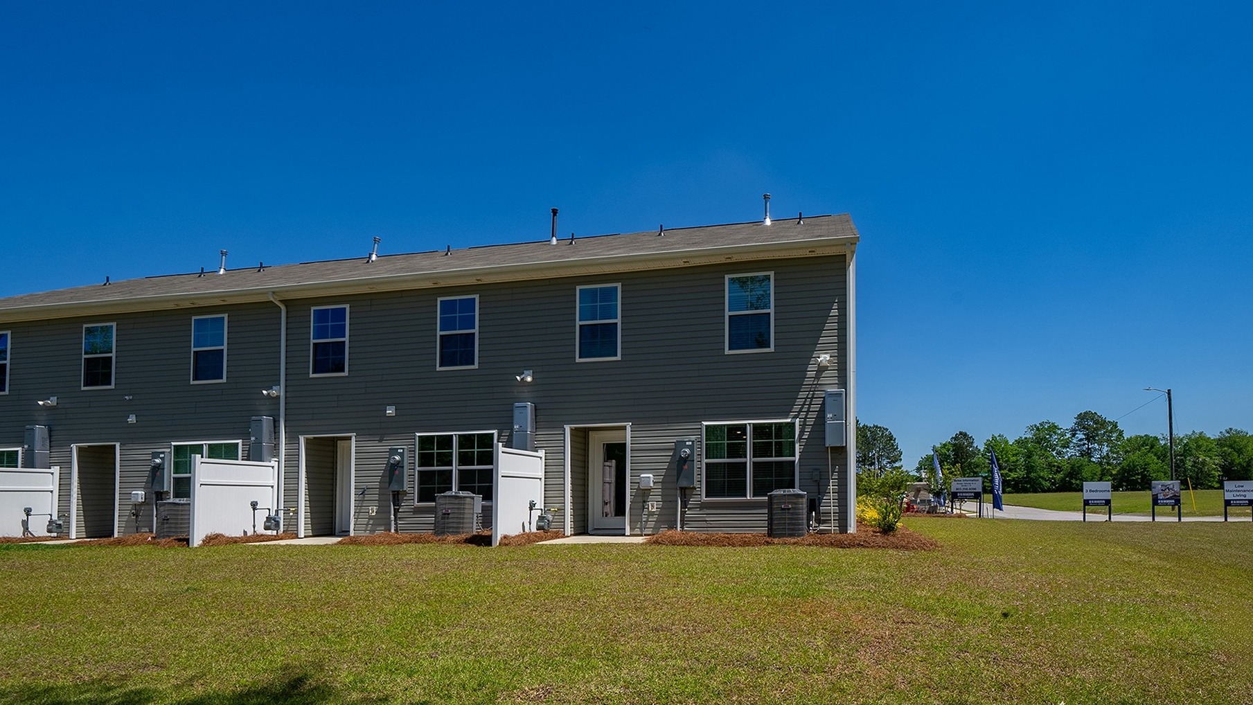 Back exterior of the home with paved patio