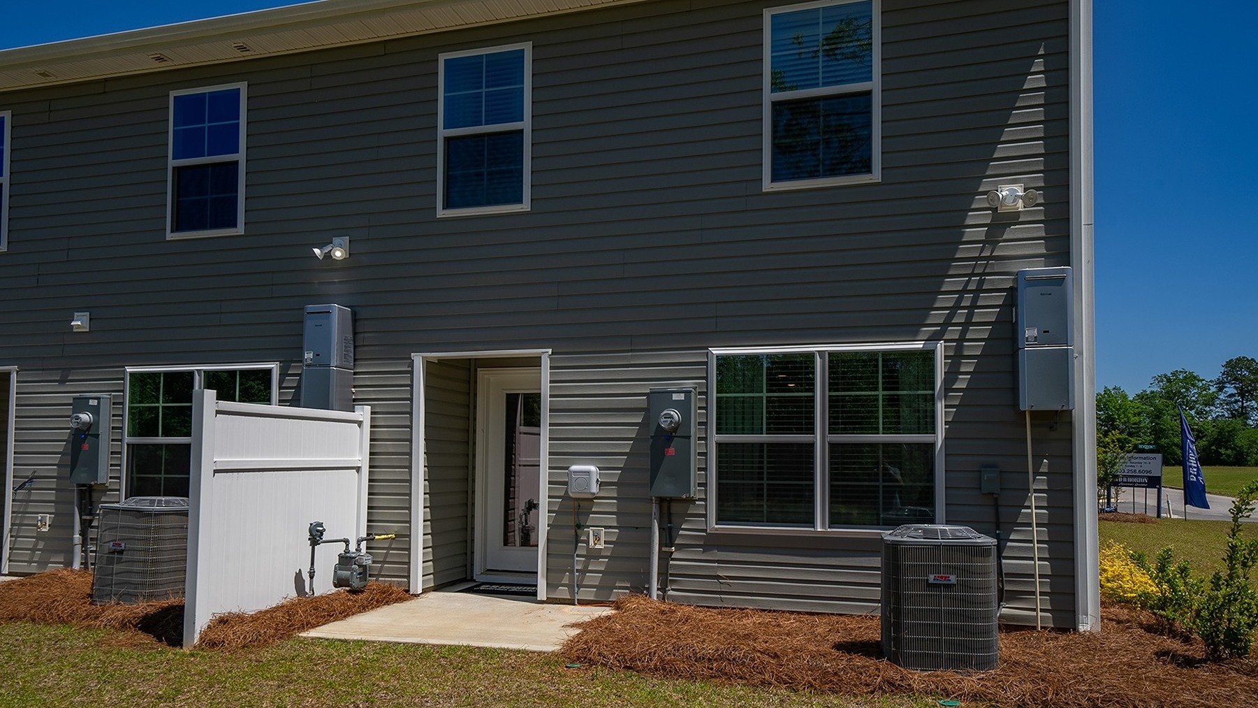 Back exterior of the home with paved patio