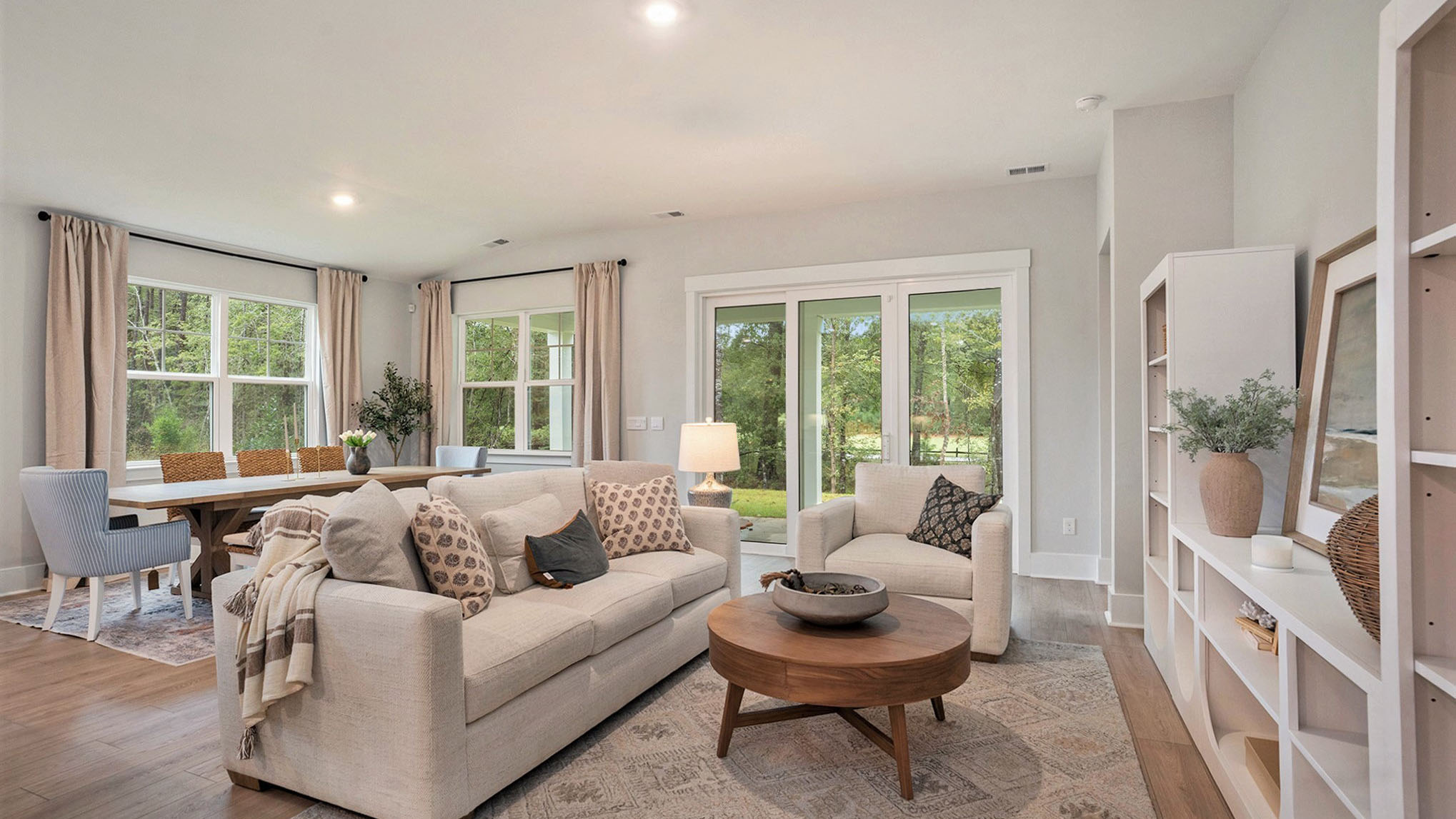 Open living space with sliding glass doors leading to the covered back patio