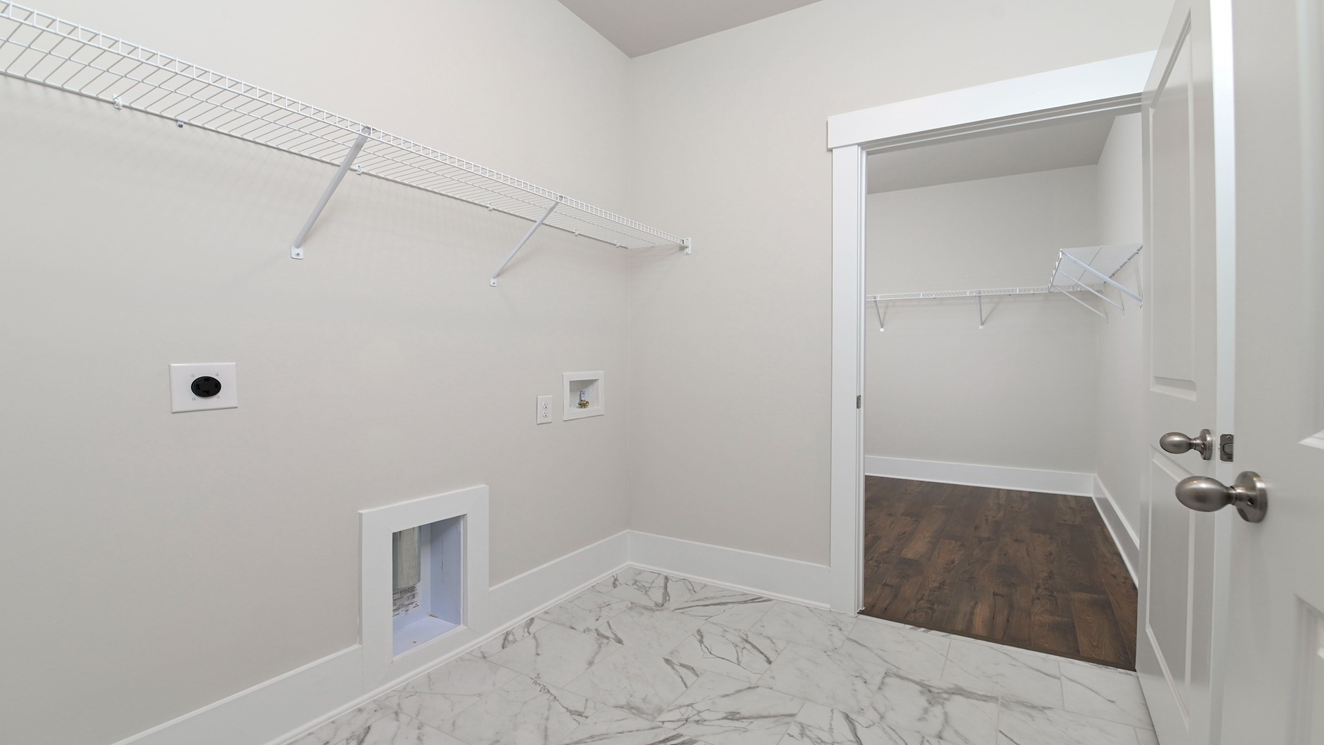 Centrally located laundry room in single-story new construction home in Dorset Ridge