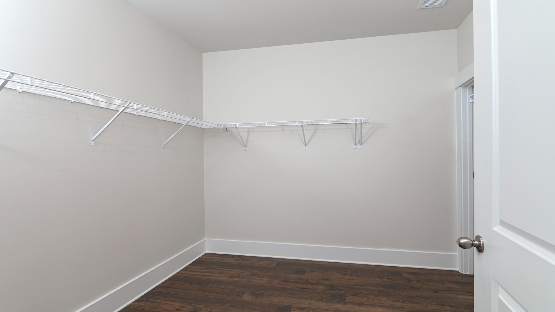 Large, walk-in primary closet in new home in 55+ neighborhood