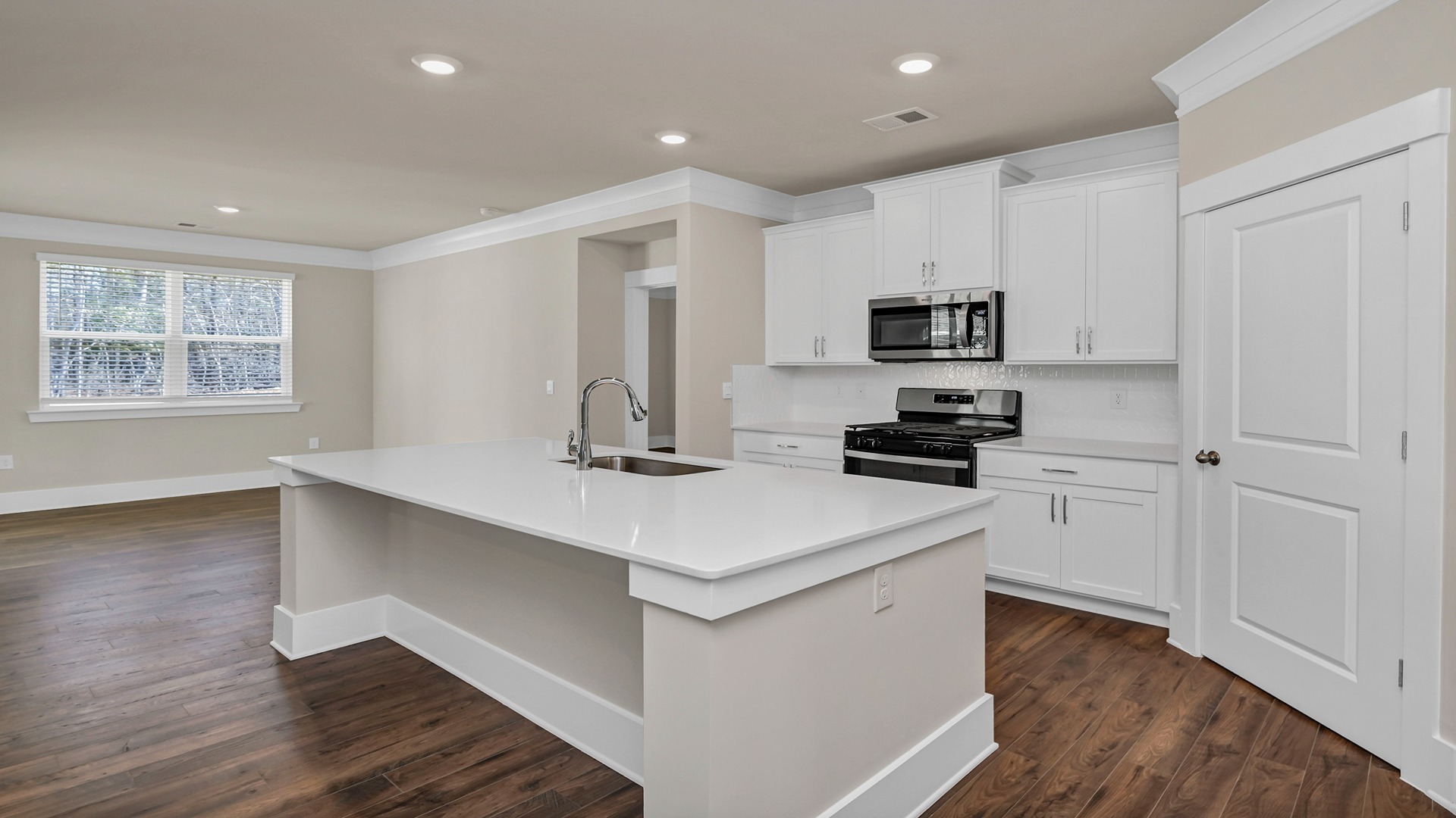 White quartz countertops in the modern kitchen of the Bradford floor plan in Dorset Ridge