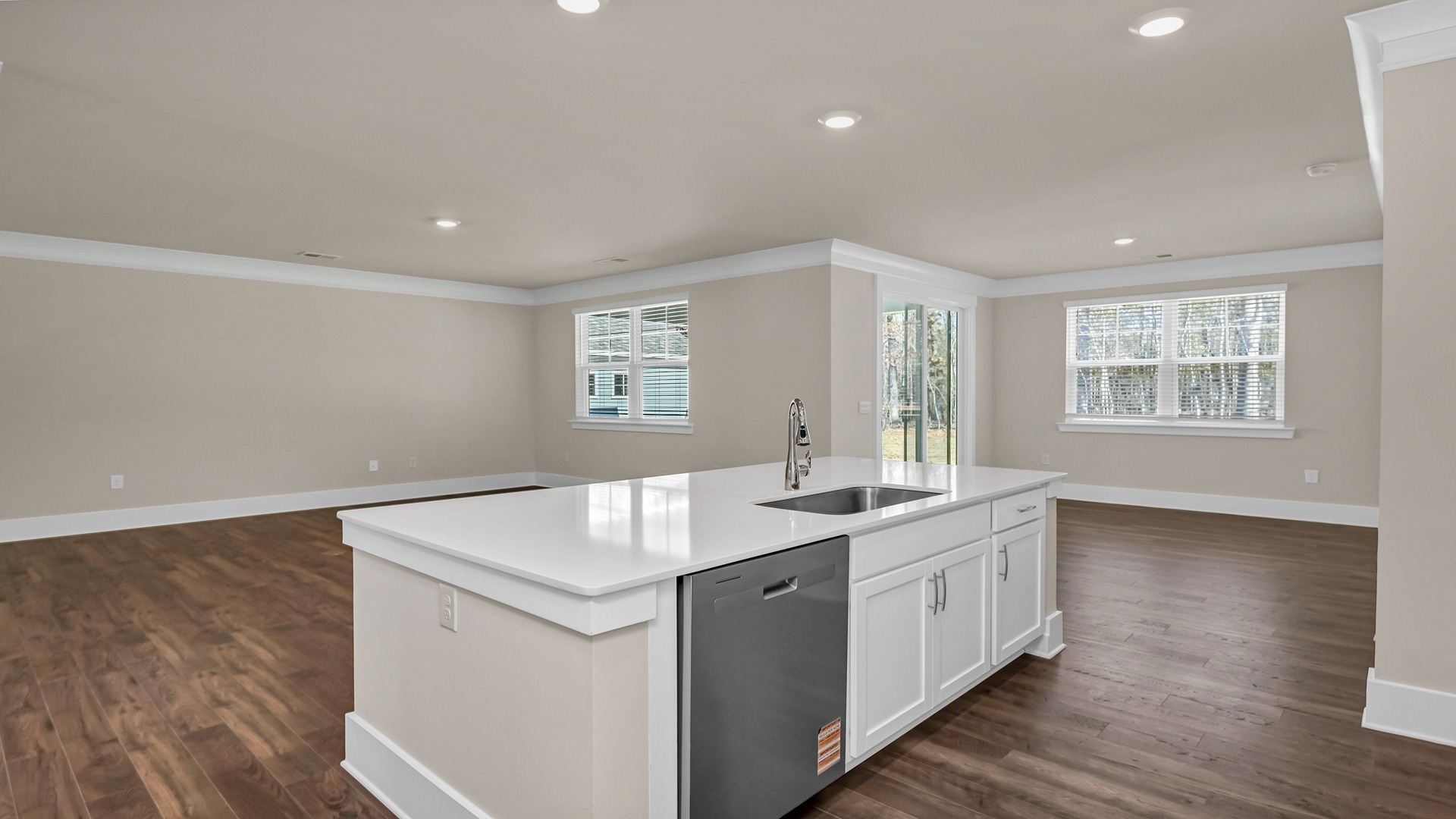 Floating kitchen island overlooks the dining and living areas in new home for sale